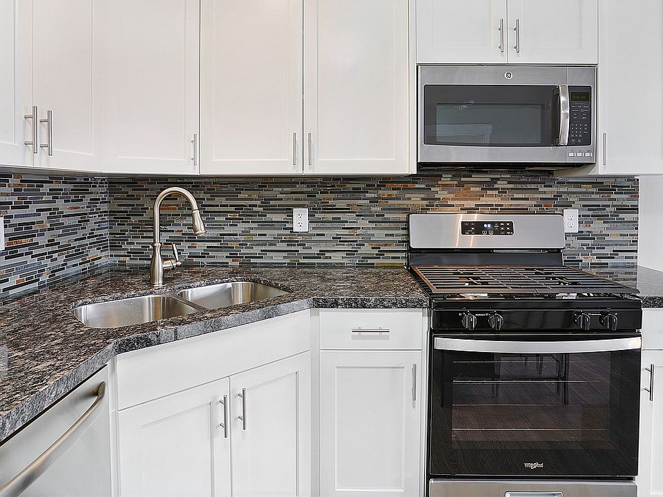 Granite countertops and stainless steel appliances create a modern kitchen experience.
