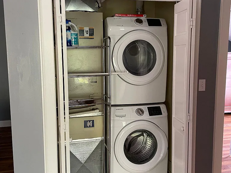 Convenient laundry closet has a full-sized washer and dryer