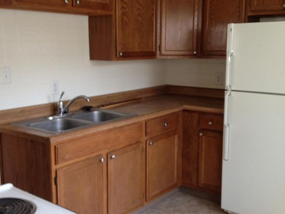 Kitchen has lots of cabinets for storage. Room for bistro table by windows.