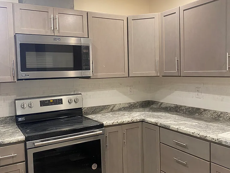 New Stainless Steel Appliances and custom tiled backsplash.