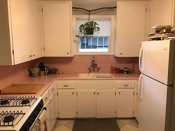 Kitchen with gas range, tons of cabinet space, and vintage tile.