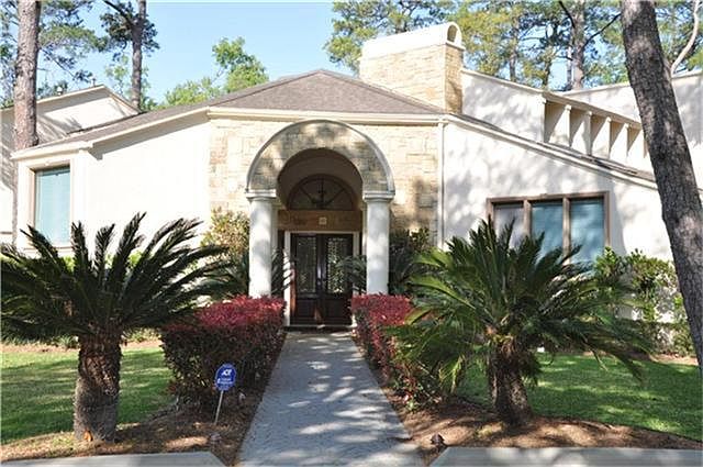 Front view of this lovely Piney Point Village home set on 0.8 acre, lavish landscaping, stone/stucco