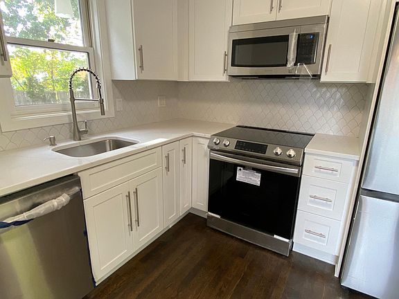 Kitchen looking out the beautiful backyard and Kelsey Springs neighborhood. Designer tiles in kitchen.