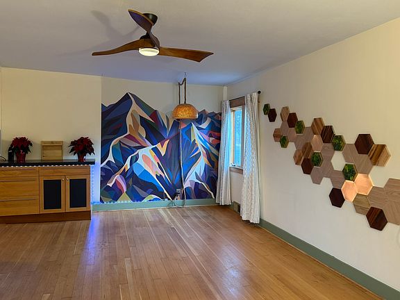 Large living room with mountain wallpaper - easy to remove if not to your taste.