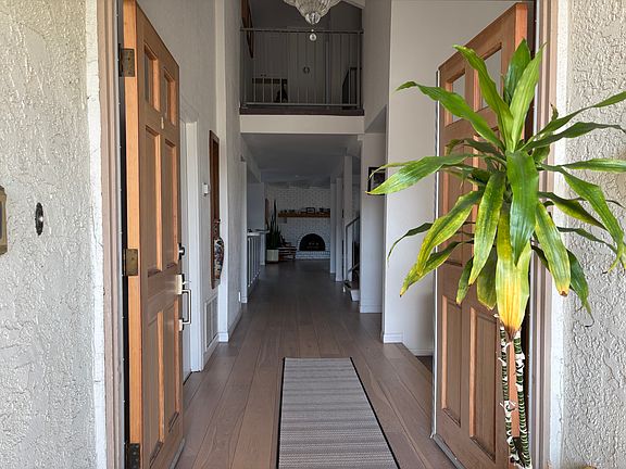 Double entry, door on left leads to attached garage. Front vaulted living room to right.