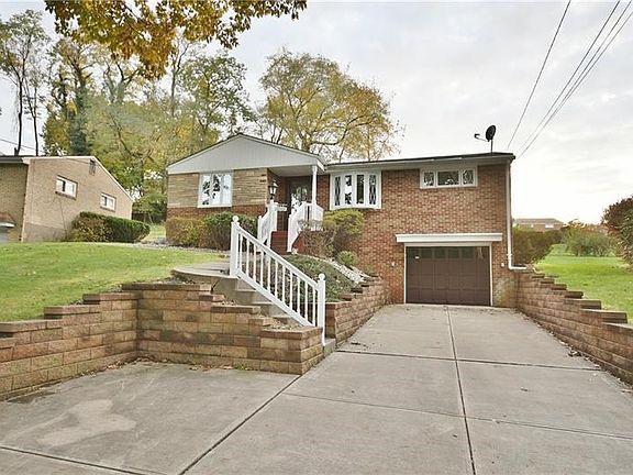 Notice the double wide driveway making parking a breeze and the newer retaining wall!