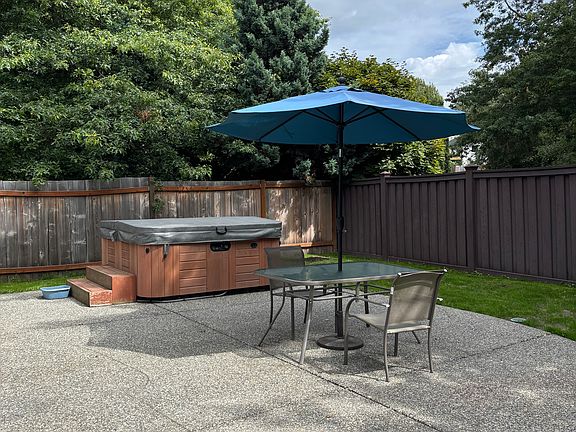 Fenced backyard with huge patio.