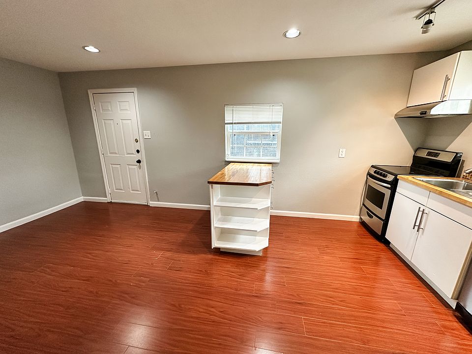 Front door and living room/kitchen space.
