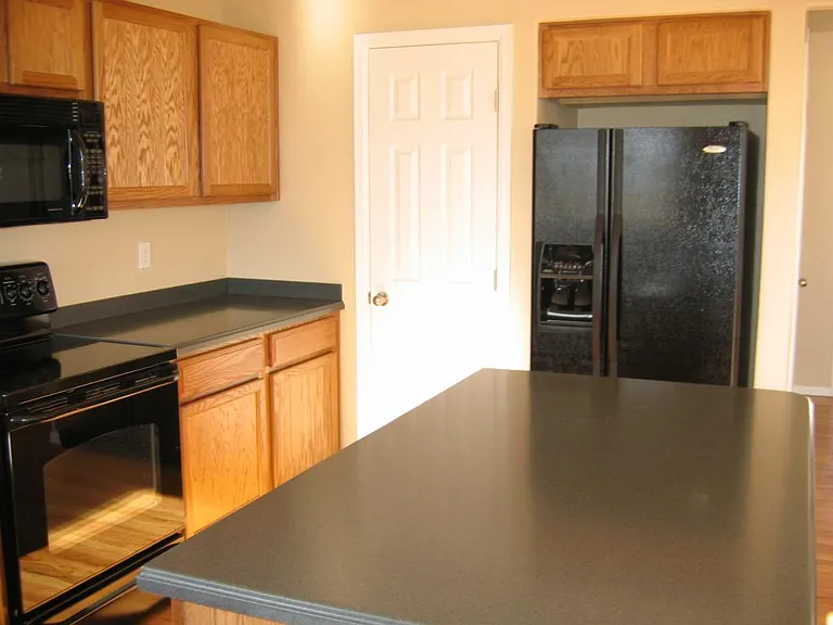 Behind the white door is a floor-to-ceiling pantry.