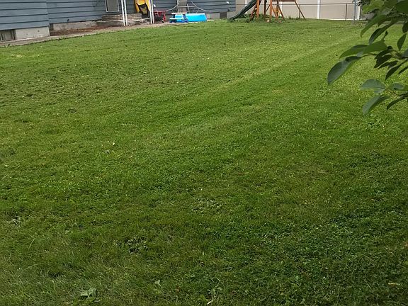 Large backyard partially fenced in.