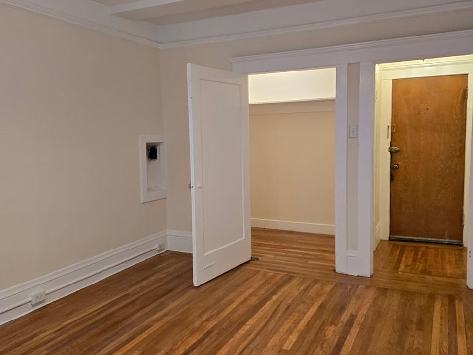 Living room with view of walk in closet and entrance