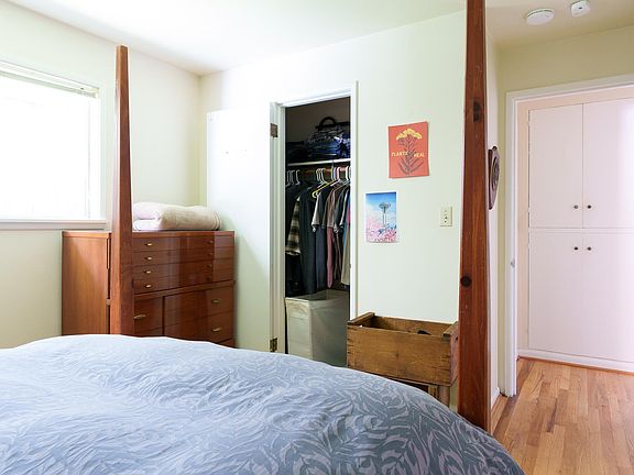 Primary bedroom closet view, storage cupboards in hallway