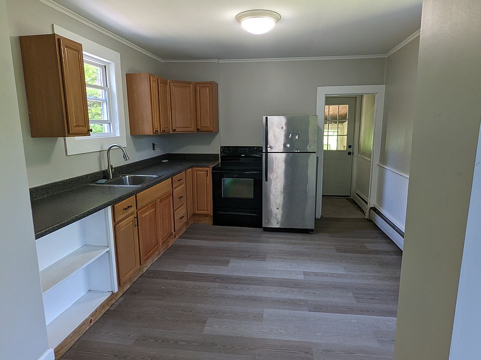 Kitchen with electric stove, fridge and storage