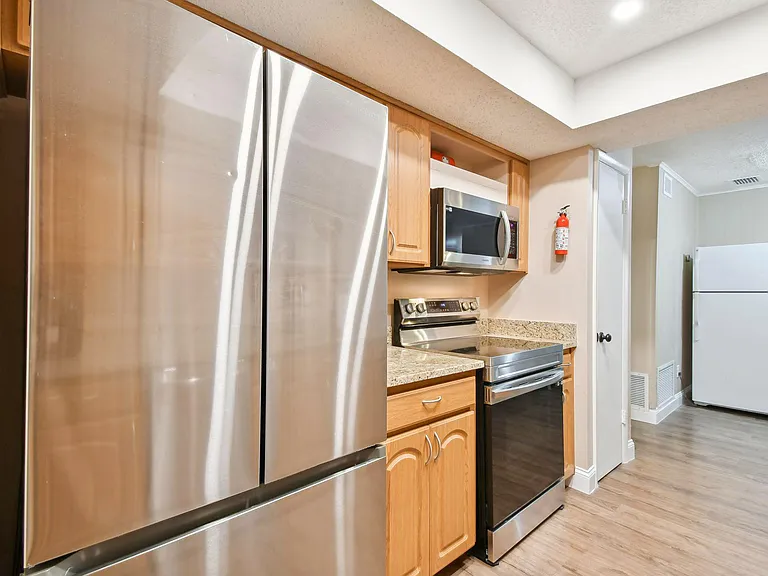 Updated kitchen with granite counter tops and stainless steel appliances