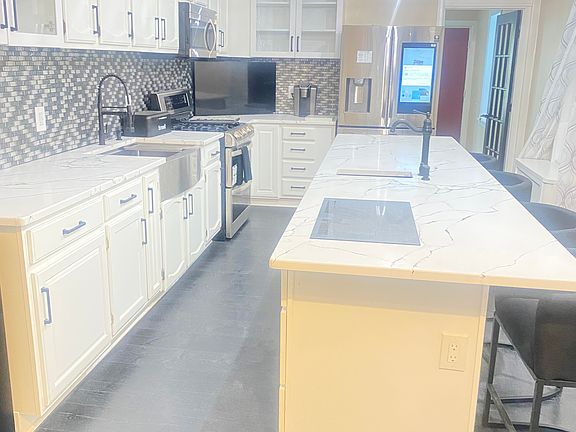 Fabulous kitchen! Extra Long Island w/ sink and extra cooktop, fridge and stove will be swopted out.
