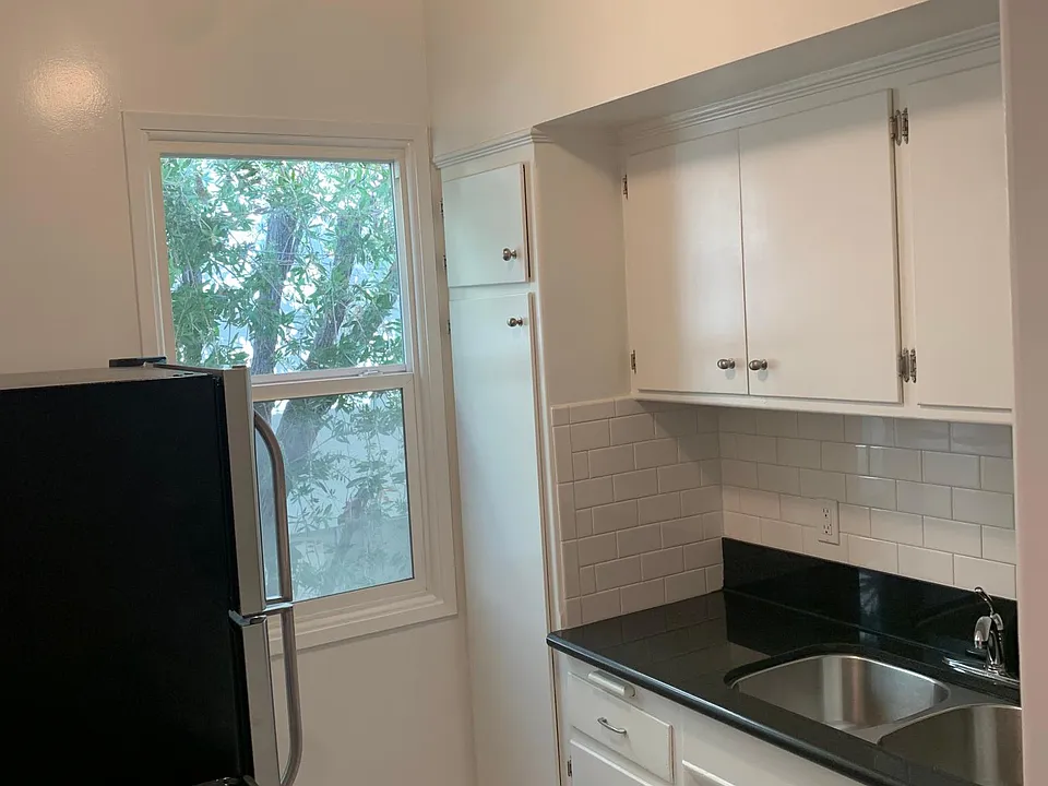 stone counters, designer tile floors. stainless steel appliances. natural light