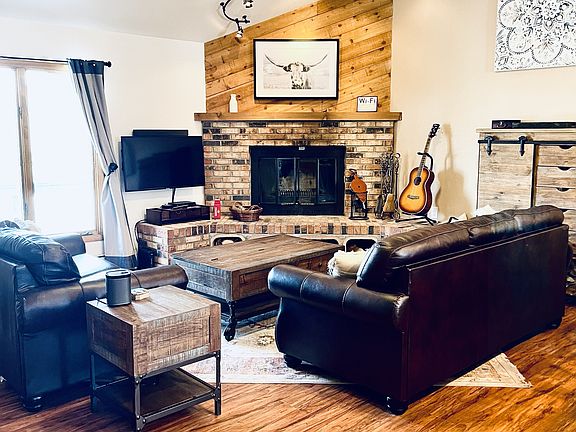 Living room on second story with wood burning fireplace
