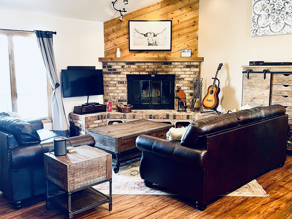 Living room on second story with wood burning fireplace