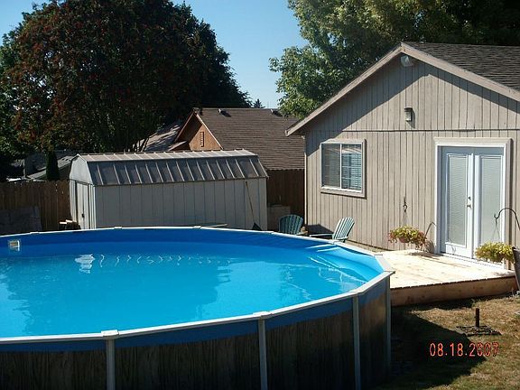 Backyard, 24 foot pool and deck, french doors.