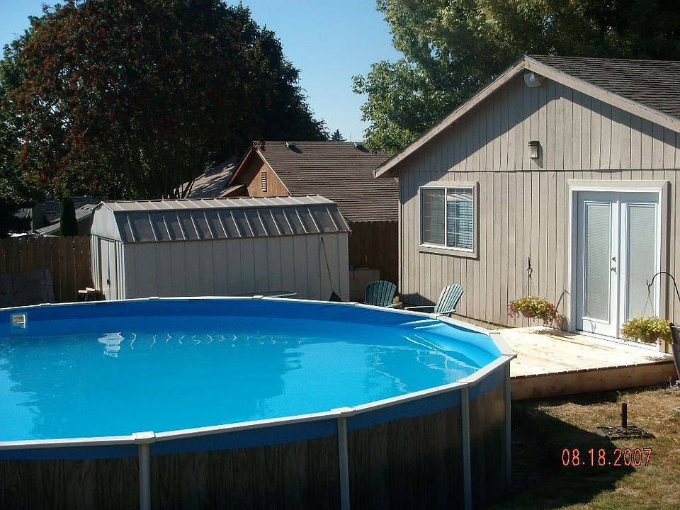 Backyard, 24 foot pool and deck, french doors.