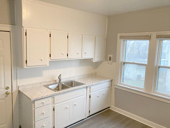 Kitchen with new sink, countertop, and new paint throughout