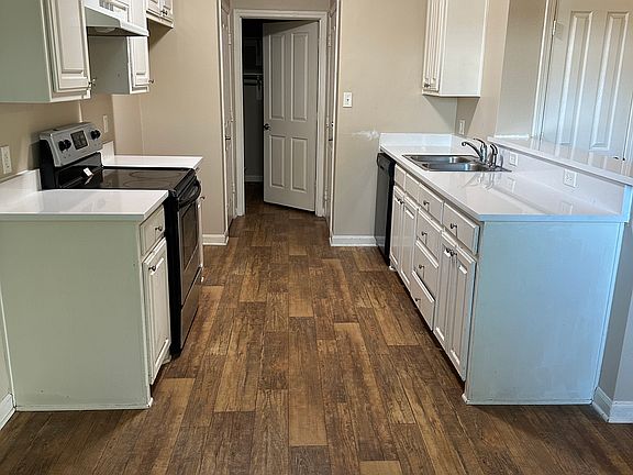 Updated kitchen with white quartz countertops, oven with glass cooktop and dishwasher included. Full size refrigerator space with ice maker hookup line.