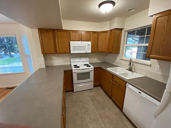 Full kitchen with new microwave and new luxury vinyl plank (LVP) floors.