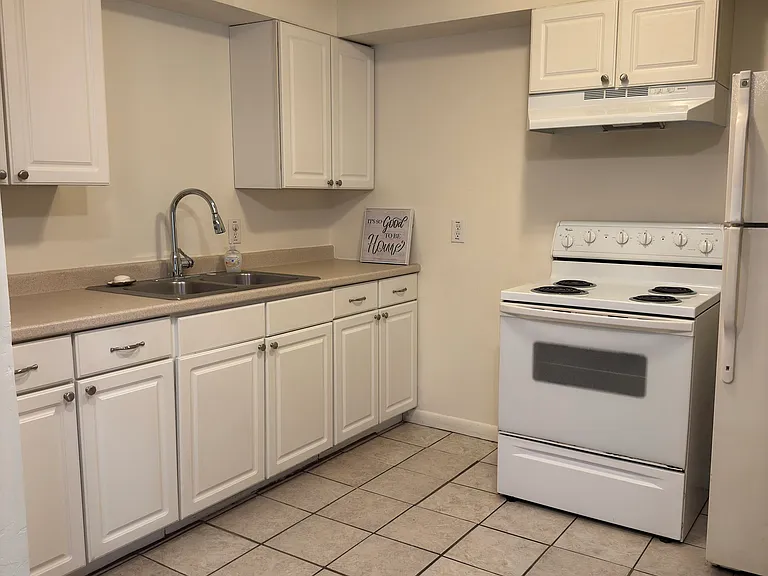 Pretty, bright kitchen with modern full sized appliances and easy care tile floor.