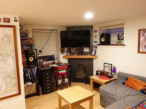 The gas fireplace provides additional warmth for the apartment beyond the house-wide heating and AC.