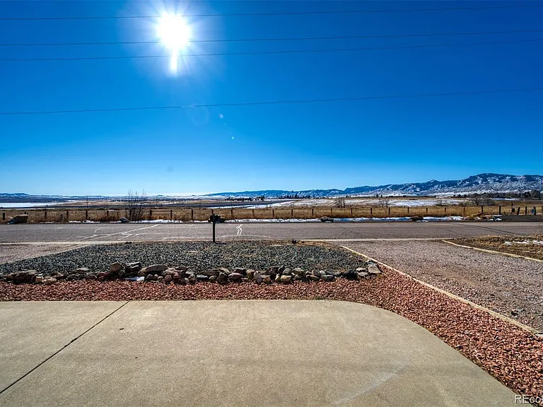 UNOBSTRUCTED VIEWS OF THE MOUNTAINS AND CHATFIELD RESERVIIOR.