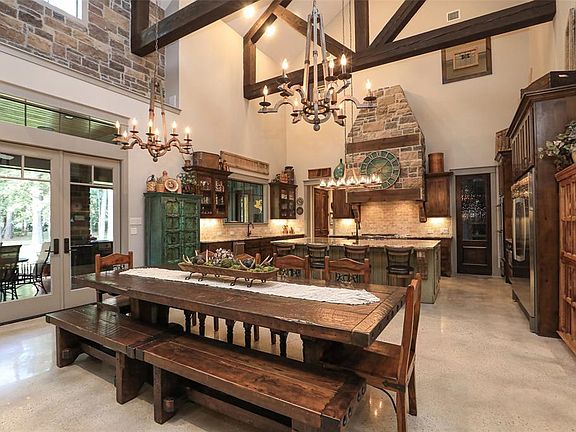GORGEOUS DINING AND KITCHEN AREA THAT IS COMBINED WITH THE GREAT ROOM! CONCRETE FLOORS! 9 FT ISLAND IN KITCHEN PLUS CATHEDRAL CEILING WITH RUSTIC ROUGH-HEWN BEAMS, TRUSSELS AND STONE WALLS!