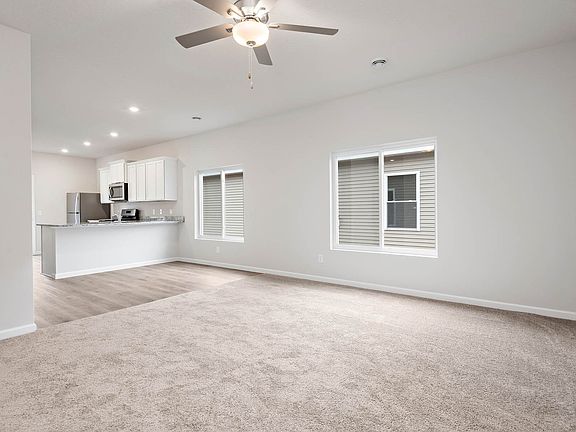 The open layout has the family room open to the kitchen