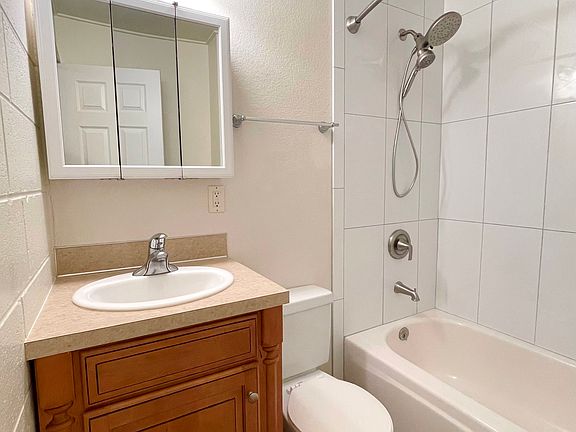 New tub surround is like this one. New cabinet is lighter maple color.