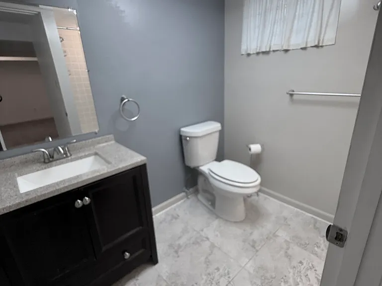 Bathroom with new remote control LED lighting fixture featuring built-in fan.