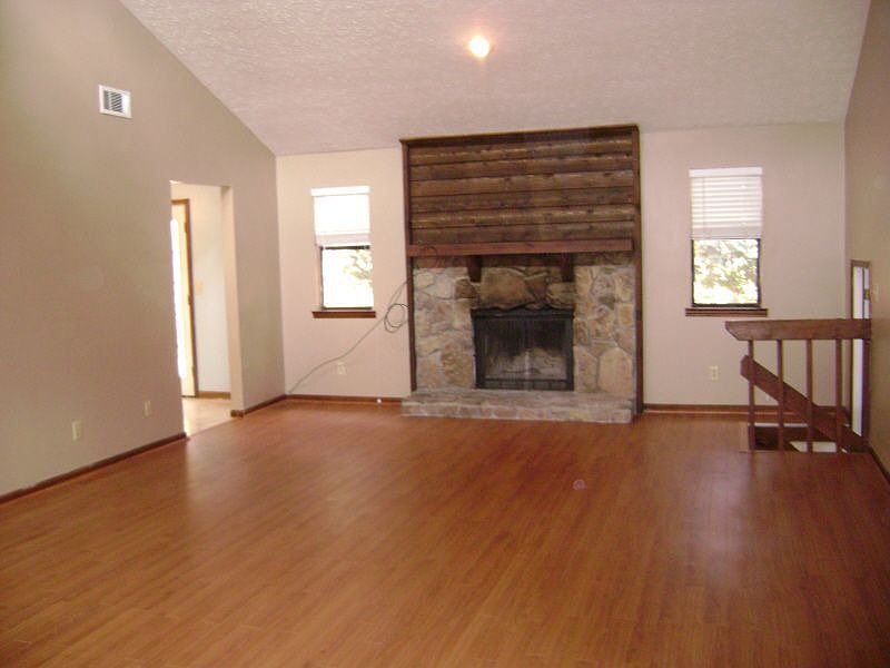 Great Roomw new harwwod floors,vaulted ceilings, and masonary fireplace!