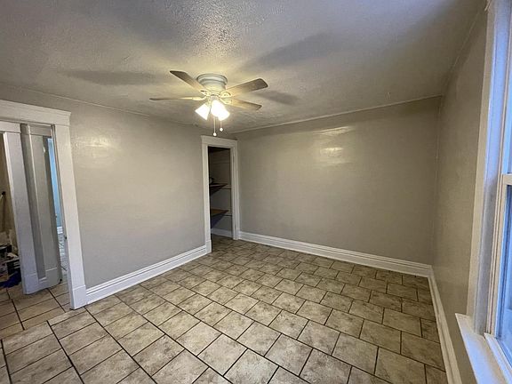 Living room with closet and 2 windows, ceiling fan