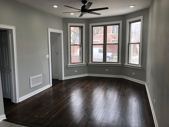Front door with entryway. The living room has large windows, perfect for watching the sunset. Just to the left is one of two bedrooms