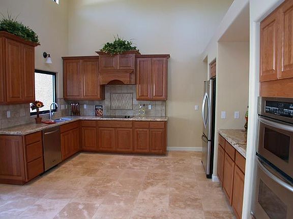 New cherry cabinets, travertine flooring, slab granite counters