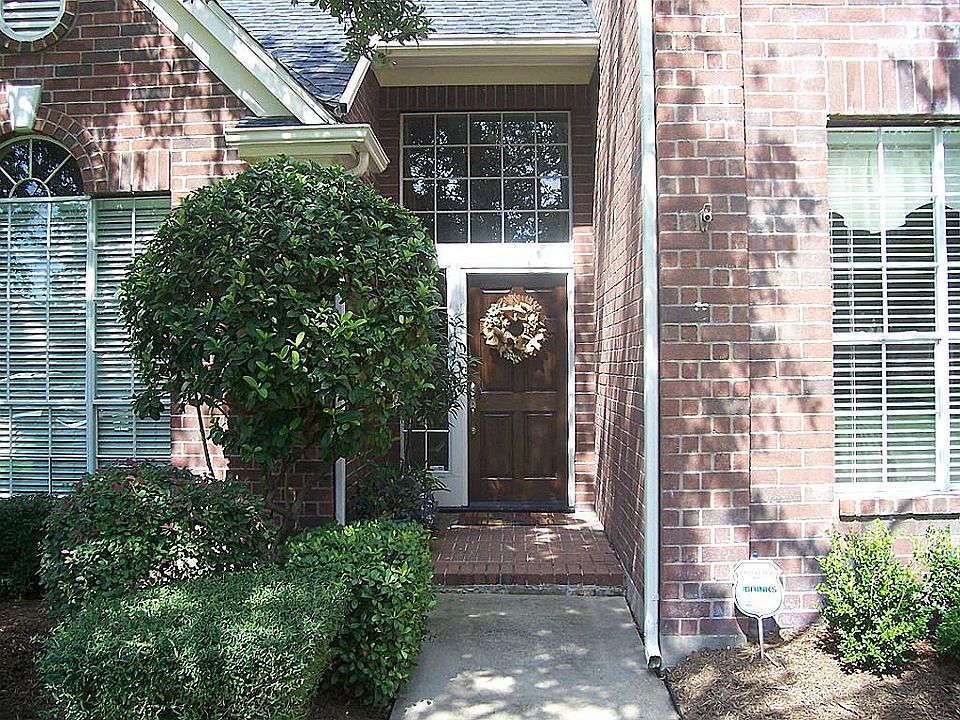 Plush Landscaping as you approach the home shows pride of ownership.