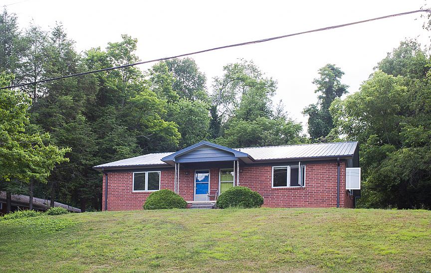 Front view of duplex. Rental is on left side with blue door.