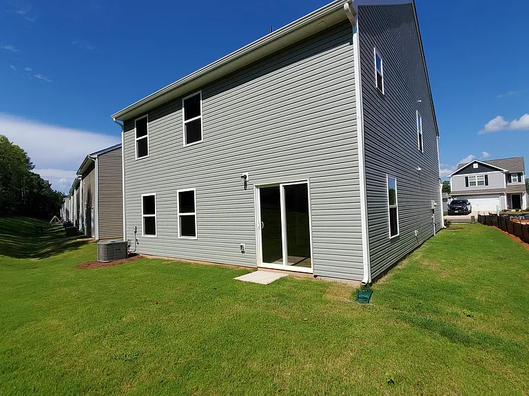 Rear View with Backyard and Side Lawn