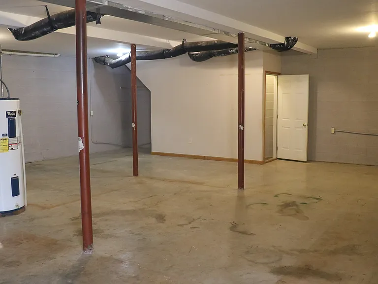 Lower Level Bonus Space: Large partially finished room with a full bathroom and full-size egress window. Ideal as a guest area, home office, gym, studio, hobby space, or optional fourth sleeping area.