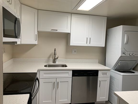 Brand new kitchen with shaker cabinets and quartz countertops.
