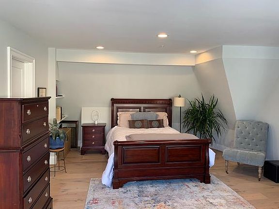 Master bedroom with Queen bed, seating chair and plenty of dressers