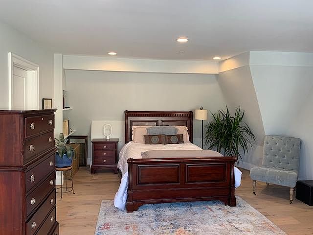Master bedroom with Queen bed, seating chair and plenty of dressers