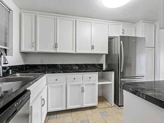 Kitchen, with new paint, new fridge, new microwave . Granite counter tops dishwasher, disposal