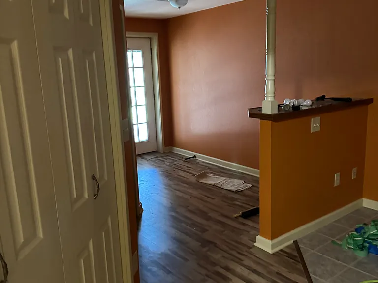 Doorway with updated flooring to the covered porch from the basement