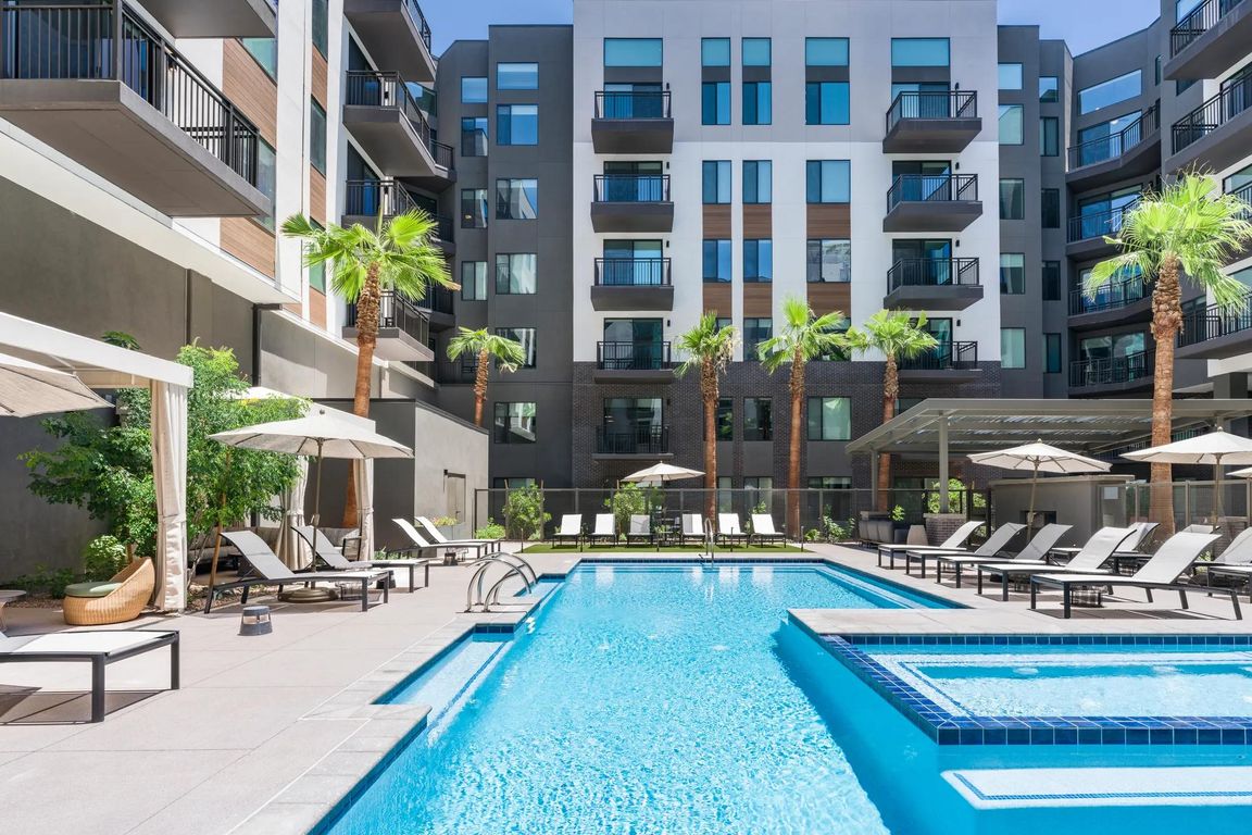 Unwind in the resort-inspired pool courtyard featuring private cabanas, a sun shelf, and ample lounge seating for elevated relaxation.