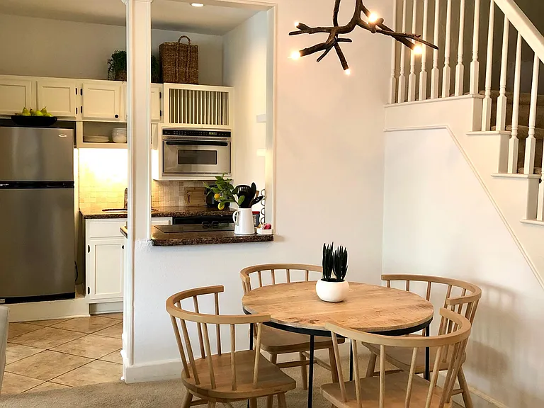 New modern dining table and chairs with West Elm chandelier.