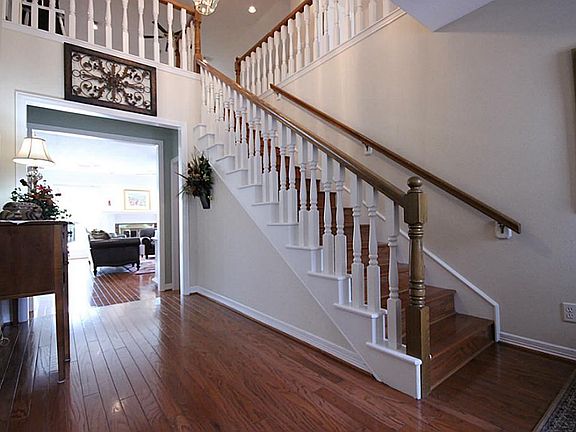 Inside the front door, you are met with a gracious staircase and gleaming hard wood floors.